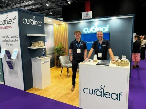 Two Curaleaf Laboratories colleagues on the stand at an industry show