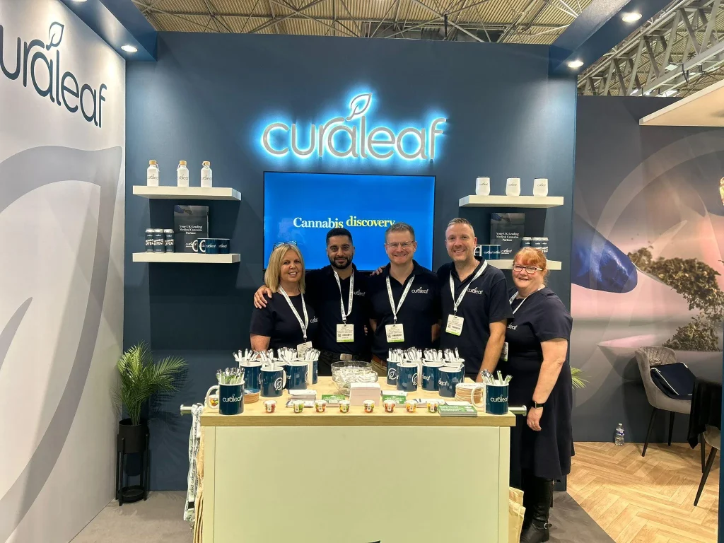 Five members of the Curaleaf team on their exhibition stand