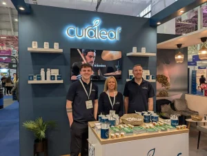Three of the Curaleaf team on the exhibition stand