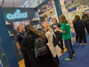 Visitors talking with the Curaleaf team on the exhibition stand