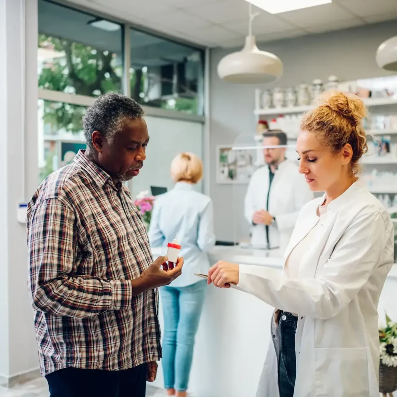 Pharmacist talking with a patient in a pharmacy