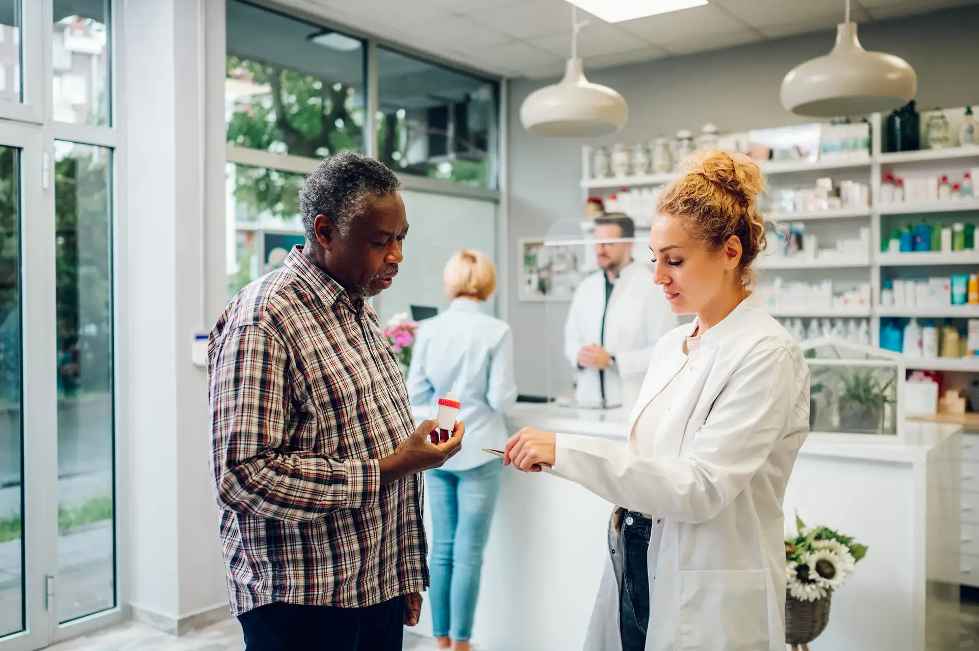 Pharmacist talking with a patient in a pharmacy